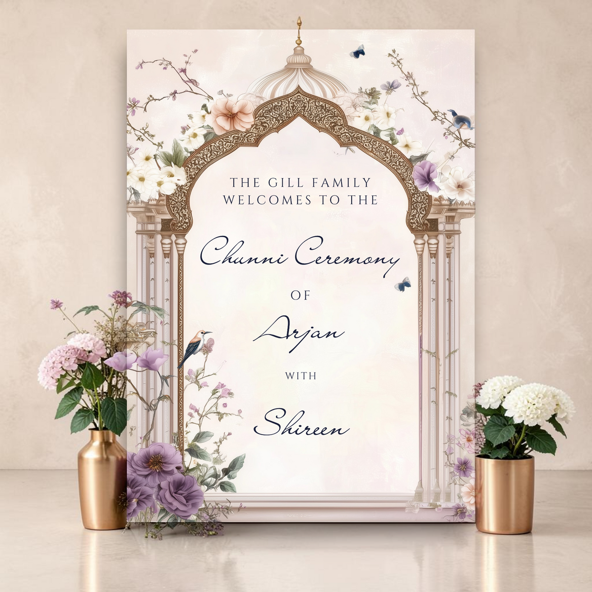 Personalised Chunni ceremony welcome sign printed on 3mm foamex. Soft blush background with ornate gold Mughal arch, purple and white florals, butterflies and birds on branches. Custom family name, bride and groom names in elegant script. A1 or A2. By Krafty Kaur.