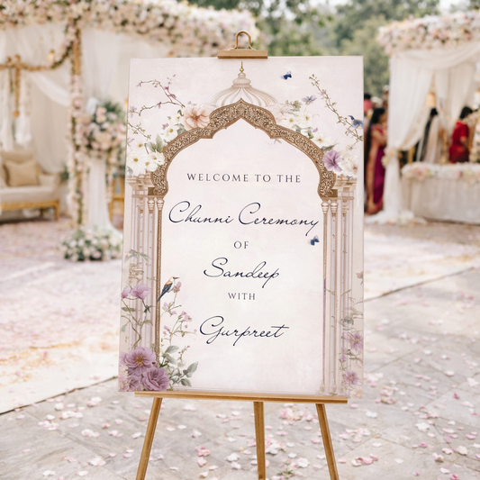 Custom Chunni ceremony welcome sign between on an easel. Blush Mughal arch design with birds and butterflies, personalised family and couple names. Printed foamex A1 or A2. Krafty Kaur.