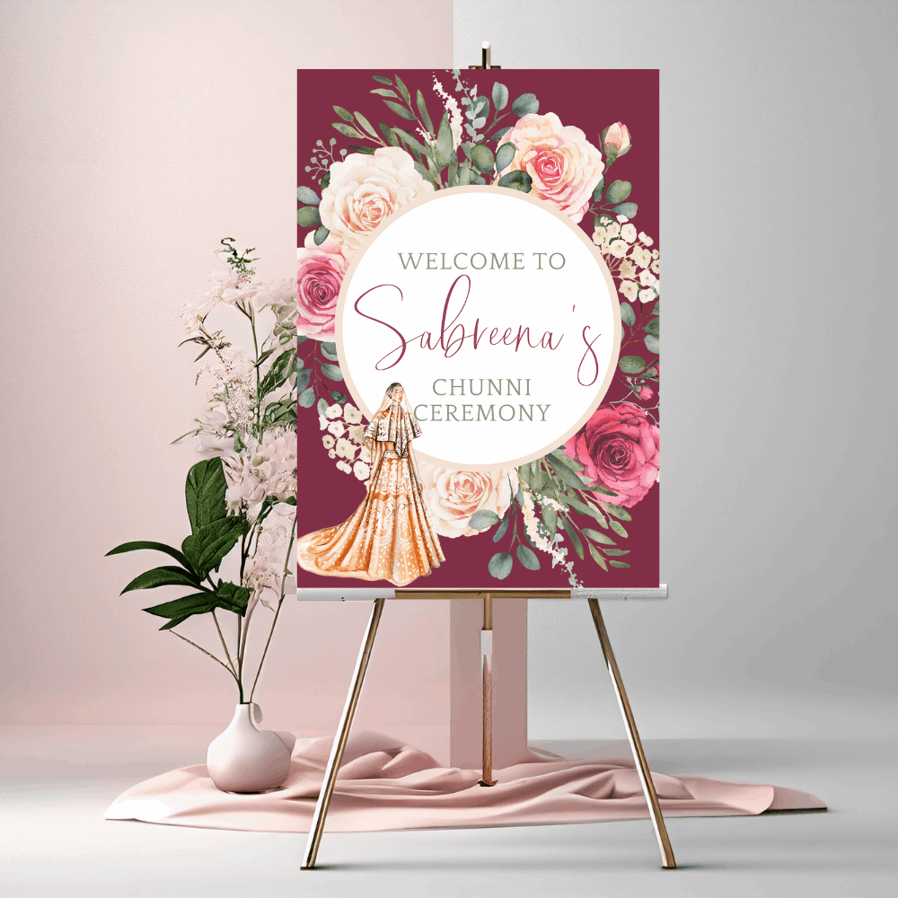 Personalised Chunni ceremony welcome sign with illustrated Indian bride in lehenga, watercolour roses and burgundy background, displayed on a wooden easel