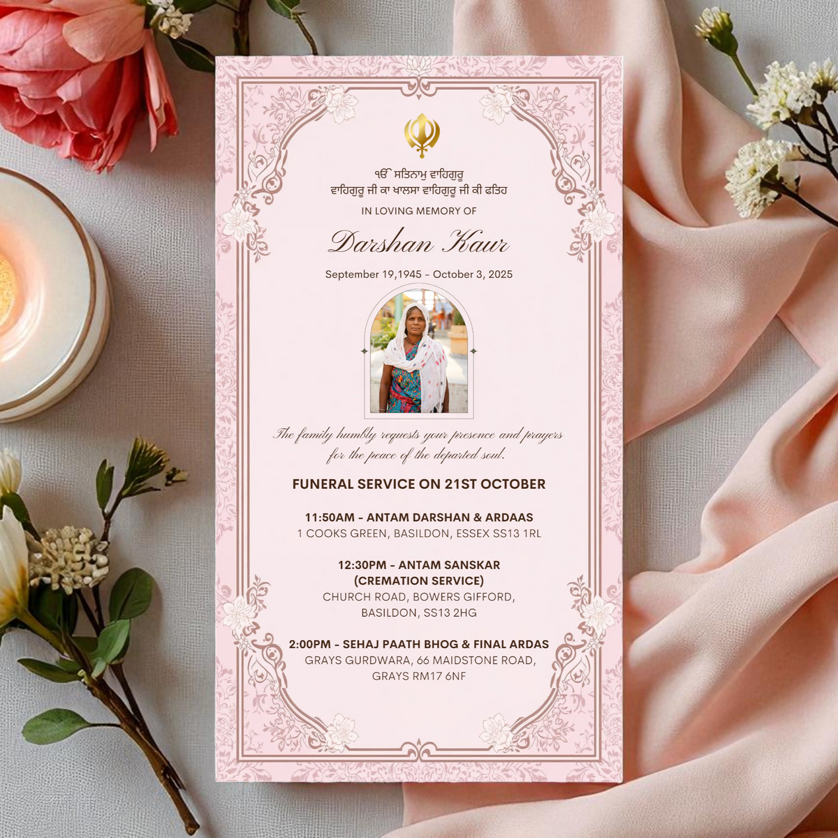 Funeral service invitation card with floral decorations on a light surface