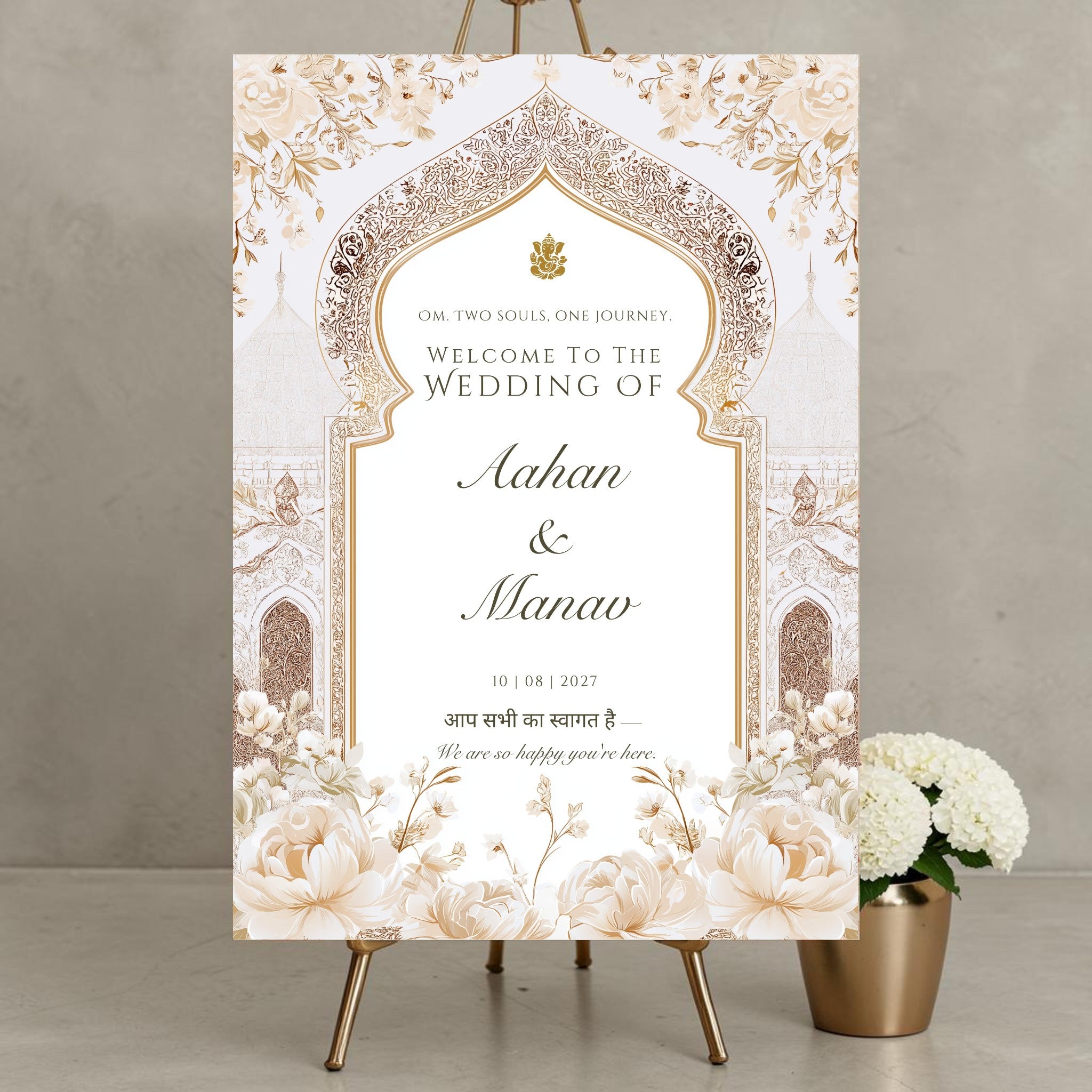 Personalised Hindu wedding welcome sign on 3mm foamex featuring Ganesh symbol, Om Two Souls One Journey tagline, ornate gold Mughal arch, ivory white peonies, Hindi script welcome phrase and couple names with wedding date in flowing script