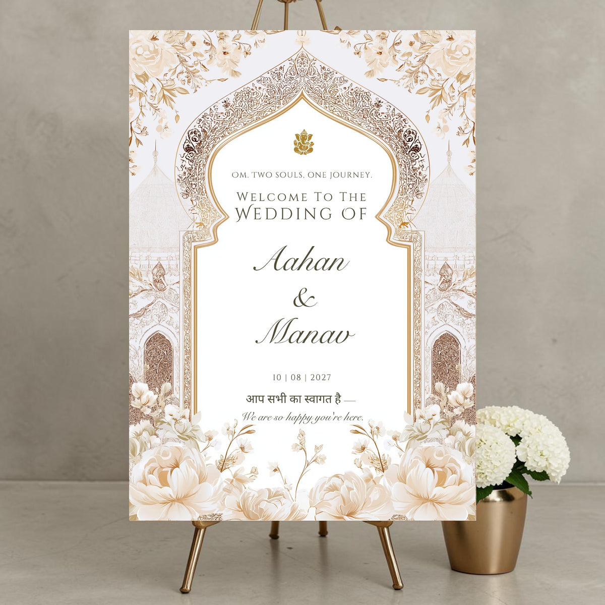 Personalised Hindu wedding welcome sign on 3mm foamex featuring Ganesh symbol, Om Two Souls One Journey tagline, ornate gold Mughal arch, ivory white peonies, Hindi script welcome phrase and couple names with wedding date in flowing script