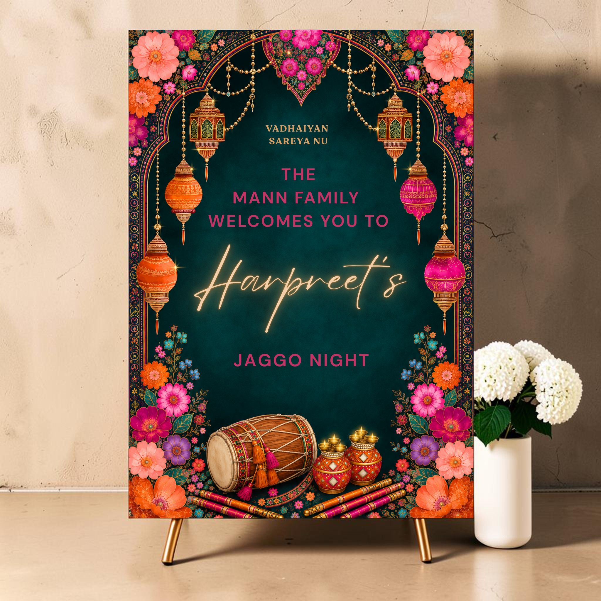 Personalised Jaggo night welcome sign printed on 3mm foamex. Dark teal background with ornate Mughal arch, hanging gold orange and pink lanterns, vibrant multicolour florals, dhol drum and matka pots. Vadhaiyan Sareya Nu greeting, custom family name and bride or groom name in gold neon script. A1 or A2. By Krafty Kaur.
