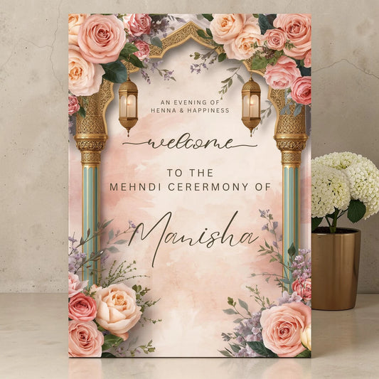 Personalised Mehndi ceremony welcome sign printed on 3mm foamex featuring ornate gold Moroccan lanterns, blush and peach roses and watercolour arch on peach background displayed on surface