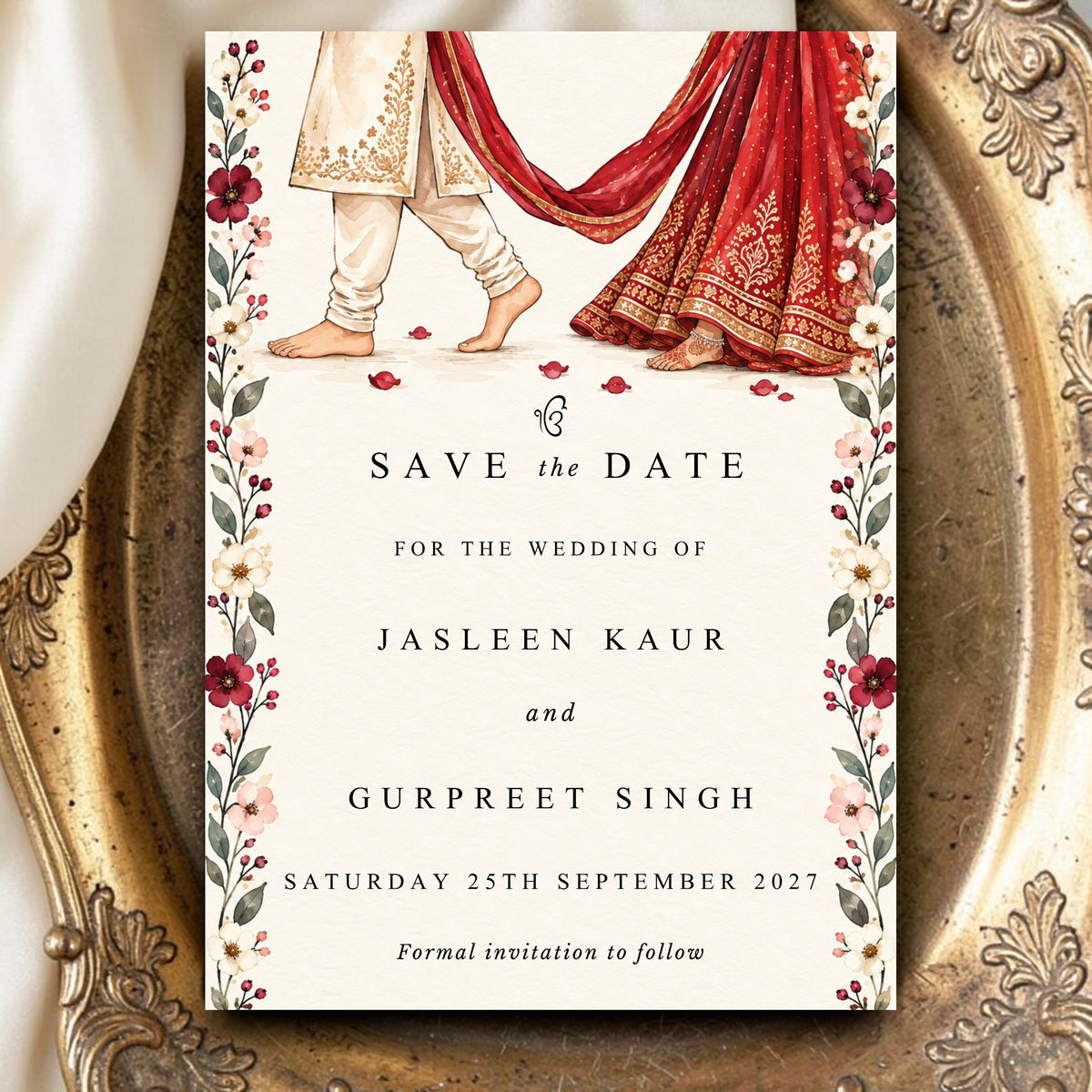 Sikh wedding Save the Date on iPad showing illustrated Anand Karaj couple in red lehenga and cream sherwani with crimson wildflower border and Ek Onkar — editable Canva template WhatsApp