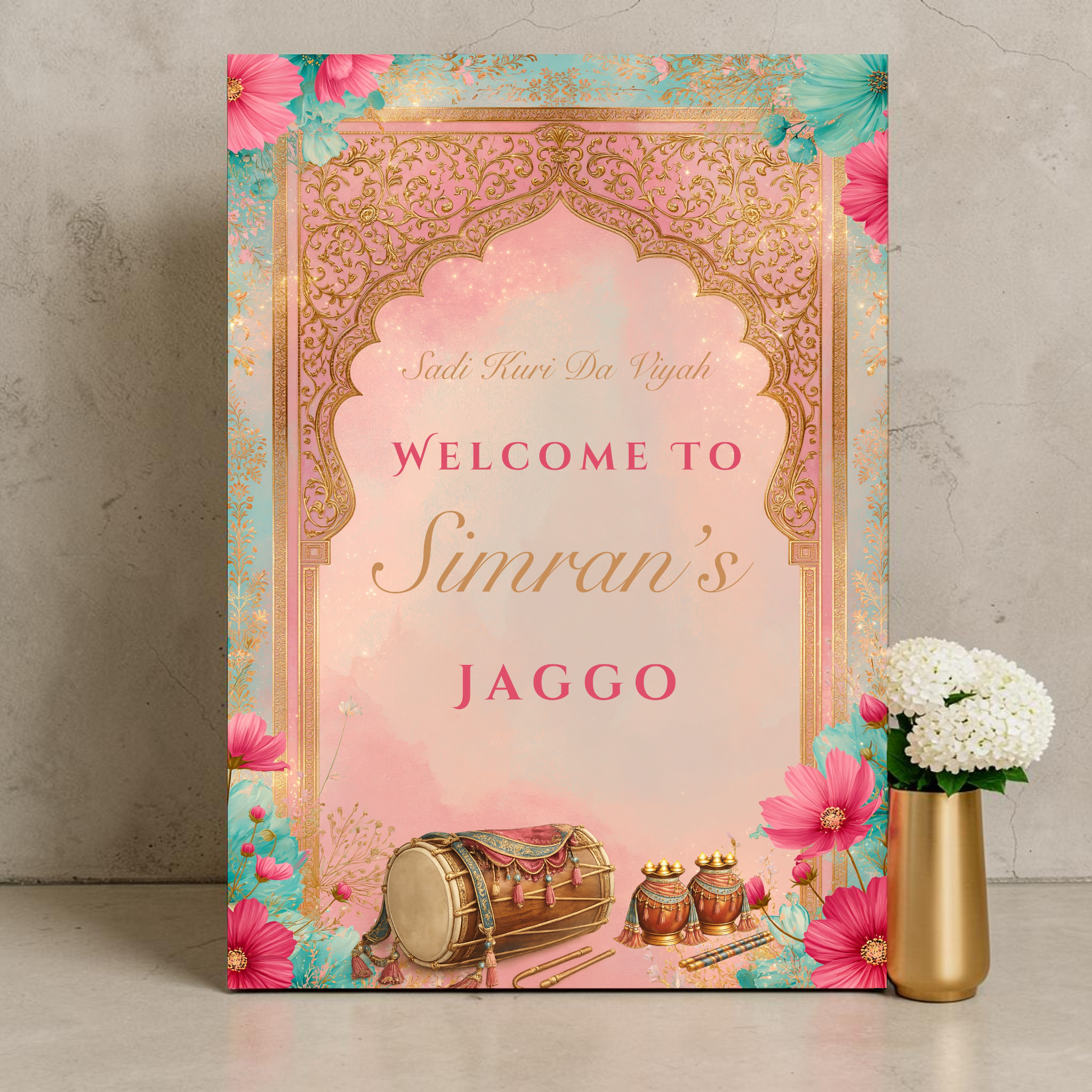 Personalised Punjabi Jaggo night welcome sign printed on 3mm foamex. Pink and teal background with ornate gold Mughal arch, dhol drum and matka pots illustration, hot pink and teal florals. Sadi Kuri Da Viyah text, custom bride name in gold script. A1 or A2. By Krafty Kaur.

