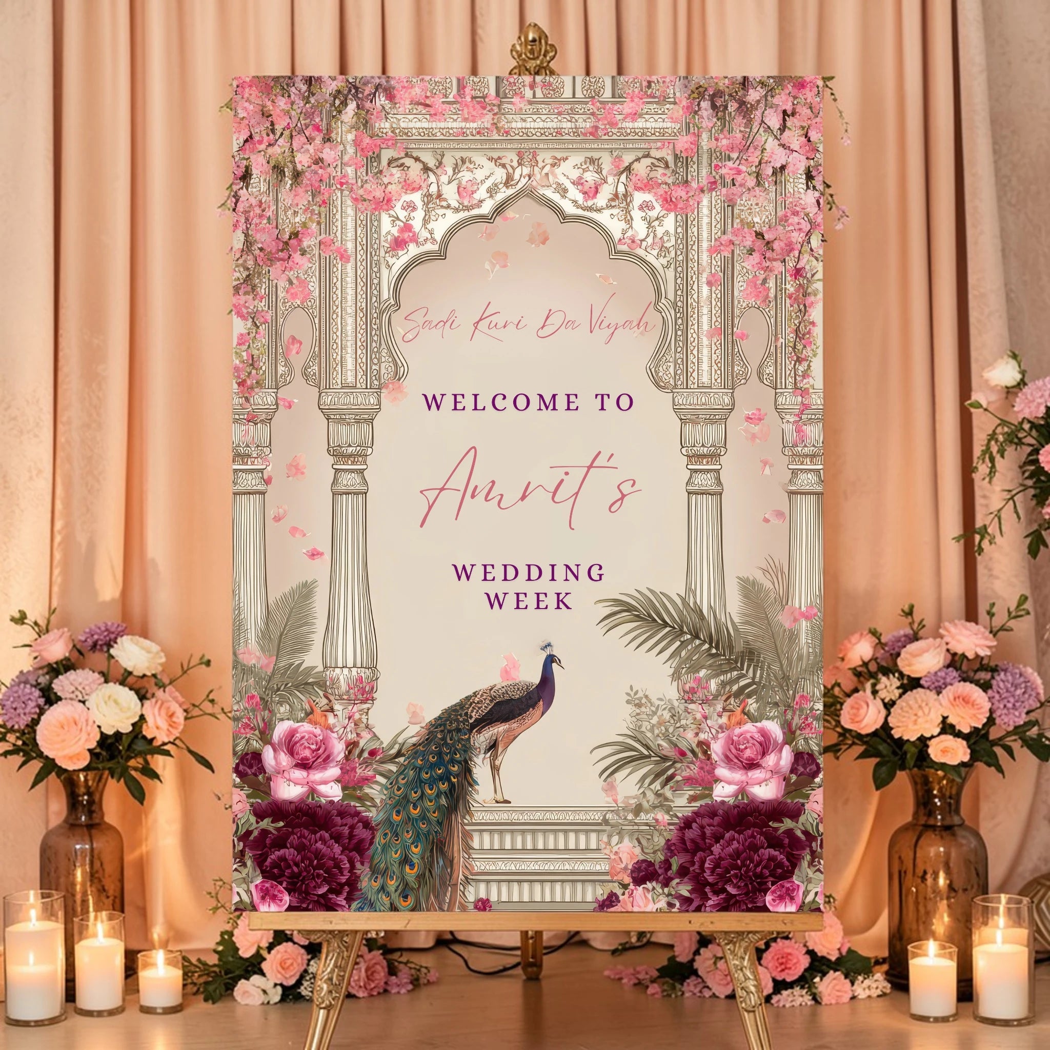 Close-up of Punjabi wedding week sign showing Sadi Kuri Da Viyah in pink script font with personalised bride name and Welcome To wording on blush Mughal arch background