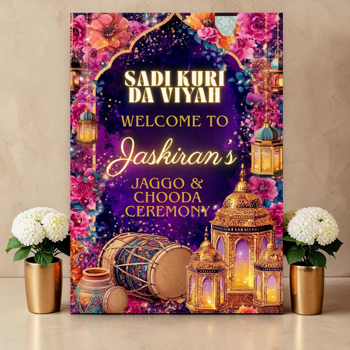 Personalised Jaggo and Chooda ceremony welcome sign printed on 3mm foamex. Deep purple background with gold Mughal arch, glowing gold lanterns, dhol drum, jewelled pot, vibrant pink and orange florals. Sadi Kuri Da Viyah text with custom bride's name in gold script. A1 or A2. By Krafty Kaur.