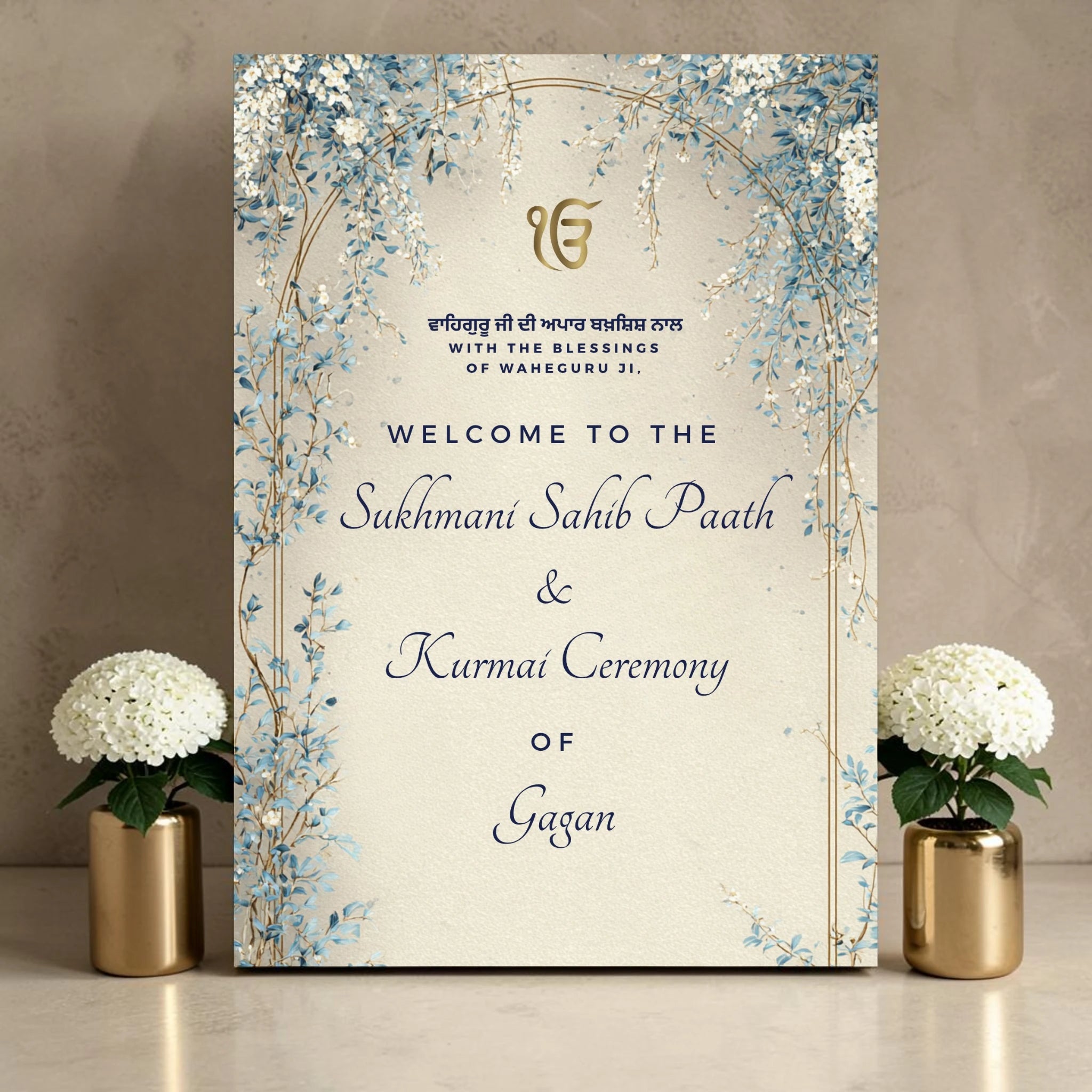 Personalised Kurmai ceremony and Sukhmani Sahib Paath welcome sign on 3mm foamex featuring gold Ik Onkar symbol, Gurmukhi script Waheguru blessing with English translation, dusty blue and white wisteria floral arch on cream textured background with personalised name in script font