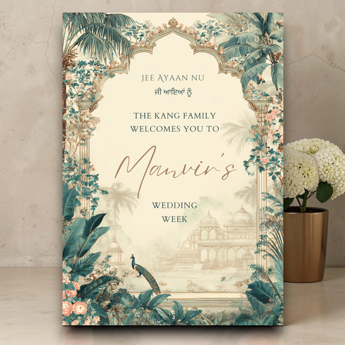 Personalised Indian wedding week welcome sign printed on 3mm foamex featuring teal tropical Mughal arch with peacock illustration, palace silhouette, blush florals and Jee Ayaan Nu Gurmukhi script on ivory background