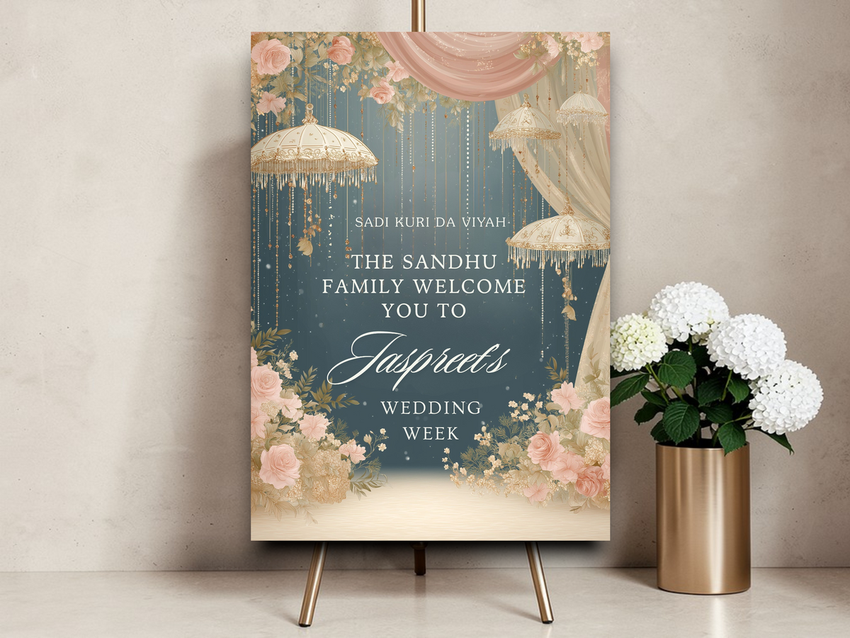 Personalised Punjabi bride wedding week welcome sign printed on 3mm foamex. Deep teal background with hanging gold Indian umbrellas, blush pink roses, draped fabric canopy and gold botanical detail. Sadi Kuri Da Viyah text, custom family name and bride's name in script. A1 or A2. By Krafty Kaur.