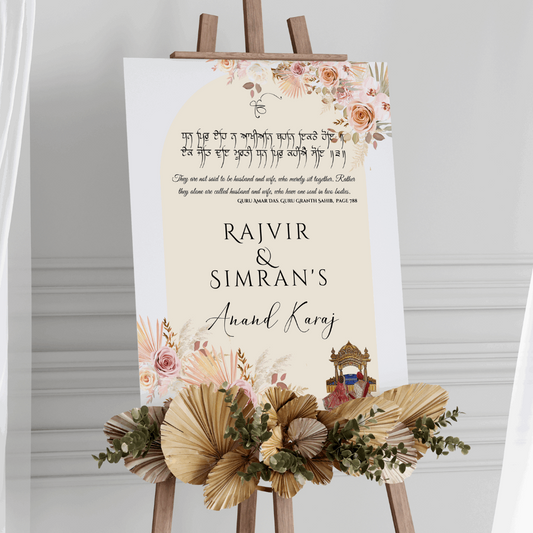 ersonalised Sikh wedding welcome sign displayed on easel at Gurdwara entrance with floral arrangements and blush pink decor