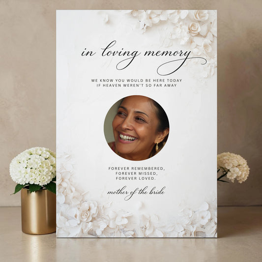 Personalised wedding memorial sign printed on 3mm foamex featuring circular photo frame surrounded by white 3D florals and ivory roses with In Loving Memory script heading Forever Remembered verse and Mother of the Bride wording on cream textured background